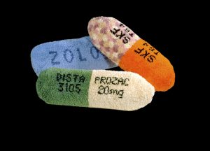 Laura Splan, Prozac, Thorazine, Zoloft, 2000, latch hook on canvas, polyester filling, 11”x36”x11”